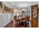 Elegant dining room with hardwood floors, a large table, and a built-in hutch at 4504 Sterling Pointe Nw Dr, Kennesaw, GA 30152