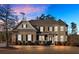 Two-story brick home with a large front yard and landscaping at dusk at 4504 Sterling Pointe Nw Dr, Kennesaw, GA 30152