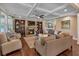 Gathering room with hardwood floors, fireplace, built-in shelving and coffered ceiling at 4504 Sterling Pointe Nw Dr, Kennesaw, GA 30152