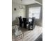 Simple dining room with four chairs and a glass-top table at 2511 Pine Tree Trl, Atlanta, GA 30349