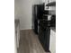 Small kitchen with black appliances and granite countertops at 2511 Pine Tree Trl, Atlanta, GA 30349