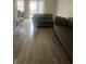 Living room featuring light gray sectional sofa and wood-look floors at 2511 Pine Tree Trl, Atlanta, GA 30349