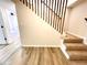 Basement stairs with wooden railing and carpeted steps at 2535 Impala Dr, Cumming, GA 30041