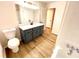 Modern bathroom with gray vanity, quartz countertop, and vinyl flooring at 2535 Impala Dr, Cumming, GA 30041