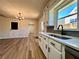 Modern kitchen with white cabinets, quartz countertops, and a farmhouse sink at 2535 Impala Dr, Cumming, GA 30041