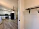 View of kitchen with gray backsplash, stainless steel appliances, and light wood flooring at 2535 Impala Dr, Cumming, GA 30041