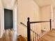 Modern staircase with dark wood railing and light-colored risers at 2535 Impala Dr, Cumming, GA 30041