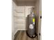 Utility closet with shelving and water heater at 2535 Impala Dr, Cumming, GA 30041