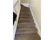 Carpeted staircase with white railing at 3103 Snapfinger Ln, Decatur, GA 30034