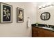 Elegant powder room with dark vanity and black granite countertop at 3280 Stillhouse Se Ln # 109, Atlanta, GA 30339