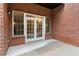 Brick patio with French doors leading to interior at 3280 Stillhouse Se Ln # 109, Atlanta, GA 30339