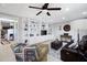 A finished basement with custom shelving around a television, tile flooring, and comfortable furniture at 416 Telfair Way, Canton, GA 30115