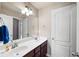 Bathroom featuring double sinks, a large mirror, and white cabinets offering a functional and stylish space at 416 Telfair Way, Canton, GA 30115