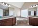 Bathroom featuring dual sinks, granite countertops, and a soaking tub creating a luxurious and relaxing experience at 416 Telfair Way, Canton, GA 30115