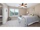 Bright bedroom with large window, fan, decor items creating a serene and comfortable retreat at 416 Telfair Way, Canton, GA 30115