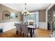 Light-filled dining room with stylish furnishings, hardwood floors, and elegant window treatments at 416 Telfair Way, Canton, GA 30115