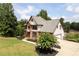 Beautiful view of a two story home with attached garage and mature landscaping at 416 Telfair Way, Canton, GA 30115