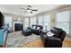 Inviting living room with a fireplace, large windows, hardwood floors, and comfortable seating at 416 Telfair Way, Canton, GA 30115