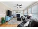 Comfortable living room featuring a fireplace, hardwood floors, large windows, and stylish decor at 416 Telfair Way, Canton, GA 30115