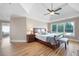 Bedroom with wood floors and tray ceiling, offering a blend of elegance and comfort with natural light from the window at 416 Telfair Way, Canton, GA 30115