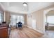 Office with a desk, chair, and natural light creating a functional workspace with hardwood floors and a neutral color scheme at 416 Telfair Way, Canton, GA 30115