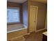 Bathroom with bathtub and separate access door at 7413 Melhana Ln, Union City, GA 30291