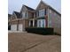 Two story house with a three car garage and mature shrubs at 7413 Melhana Ln, Union City, GA 30291
