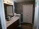 Bathroom with double vanity, stone-textured wall, and separate shower at 6053 Hemperly Rd, Atlanta, GA 30349