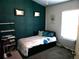 Bedroom with teal accent wall and built-in shelving at 6053 Hemperly Rd, Atlanta, GA 30349