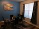 Dining area with glass table and chairs, blue walls, and hardwood floors at 6053 Hemperly Rd, Atlanta, GA 30349