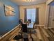 Dining room with glass table, four chairs, and blue accent wall at 6053 Hemperly Rd, Atlanta, GA 30349