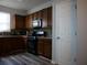 Kitchen with wooden cabinets, black appliances, and tile backsplash at 6053 Hemperly Rd, Atlanta, GA 30349