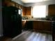 Kitchen with dark wood cabinets, black appliances, and tile backsplash at 6053 Hemperly Rd, Atlanta, GA 30349