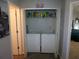 Laundry closet with washer, dryer, and shelving for cleaning supplies at 6053 Hemperly Rd, Atlanta, GA 30349