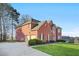 Brick home with a two-car garage and manicured lawn at 4740 Eagles Ridge Loop, Stonecrest, GA 30038