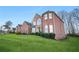Side view of a red brick house with lush green lawn at 4740 Eagles Ridge Loop, Stonecrest, GA 30038