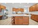 Kitchen island with wood cabinets and granite countertop at 4740 Eagles Ridge Loop, Stonecrest, GA 30038