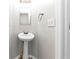 Small bathroom with pedestal sink and updated fixtures at 730 Pinehurst Dr, Fairburn, GA 30213