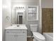 Clean bathroom with white vanity and toilet, brown tile and a window at 730 Pinehurst Dr, Fairburn, GA 30213