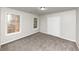 Well-lit bedroom with neutral walls, carpet and two windows at 730 Pinehurst Dr, Fairburn, GA 30213