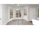 Bright breakfast area with wood-look floors and large windows at 730 Pinehurst Dr, Fairburn, GA 30213