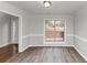 Dining room with hardwood floors, neutral walls, and large window at 730 Pinehurst Dr, Fairburn, GA 30213