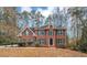 Brick two-story house with green shutters, landscaping, and a large front yard at 730 Pinehurst Dr, Fairburn, GA 30213