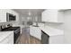 Modern kitchen with white cabinets, stainless steel appliances, and quartz countertops at 730 Pinehurst Dr, Fairburn, GA 30213