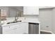 Modern kitchen with white cabinets, stainless steel appliances, and quartz countertops at 730 Pinehurst Dr, Fairburn, GA 30213