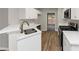 Modern kitchen with white cabinets, stainless steel appliances, and quartz countertops at 730 Pinehurst Dr, Fairburn, GA 30213