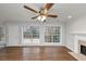 Living room with hardwood floors, fireplace and large windows at 730 Pinehurst Dr, Fairburn, GA 30213