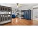 Bedroom with two sets of bunkbeds, an armoire, and hardwood floors at 1109 Wiley Bridge Rd, Woodstock, GA 30188