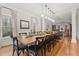 Elegant dining room featuring a large table, hardwood floors, and natural light at 1109 Wiley Bridge Rd, Woodstock, GA 30188