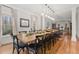 Elegant dining room featuring a large table, hardwood floors, and natural light at 1109 Wiley Bridge Rd, Woodstock, GA 30188